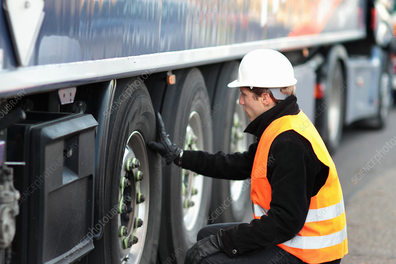 F0099544-Builder_looking_at_wheel_of_truck.jpg